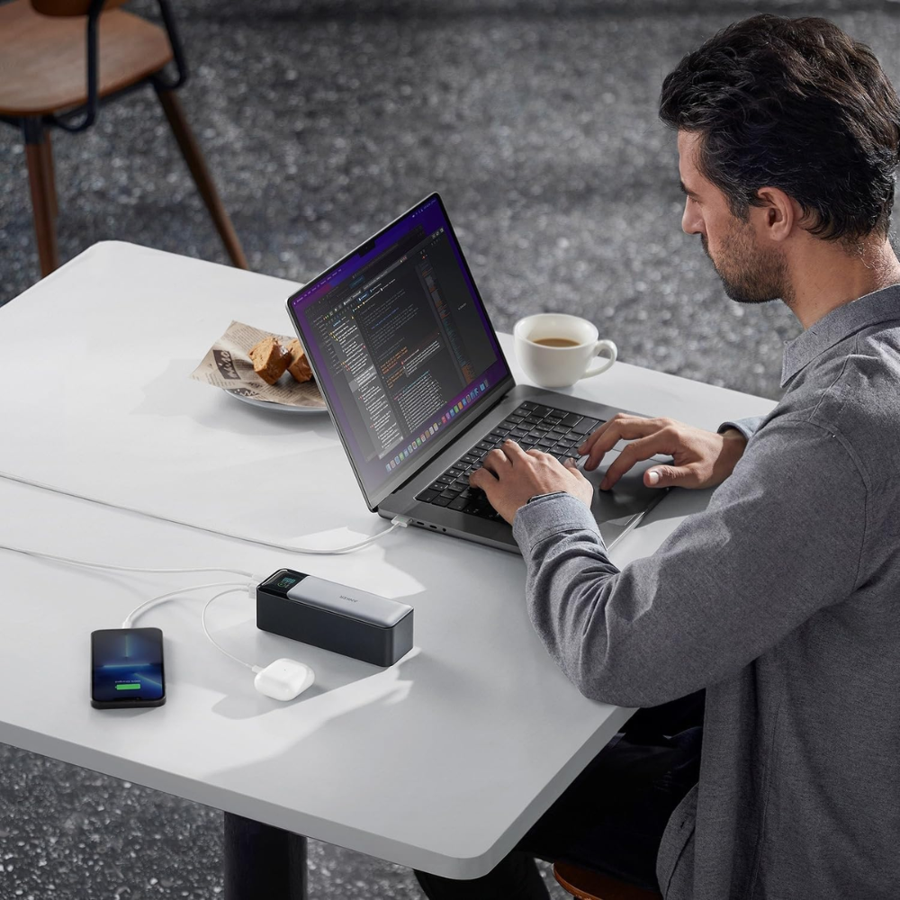 Anker 737 Power Bank 24000mAh 140W charging a laptop and mobile devices during work