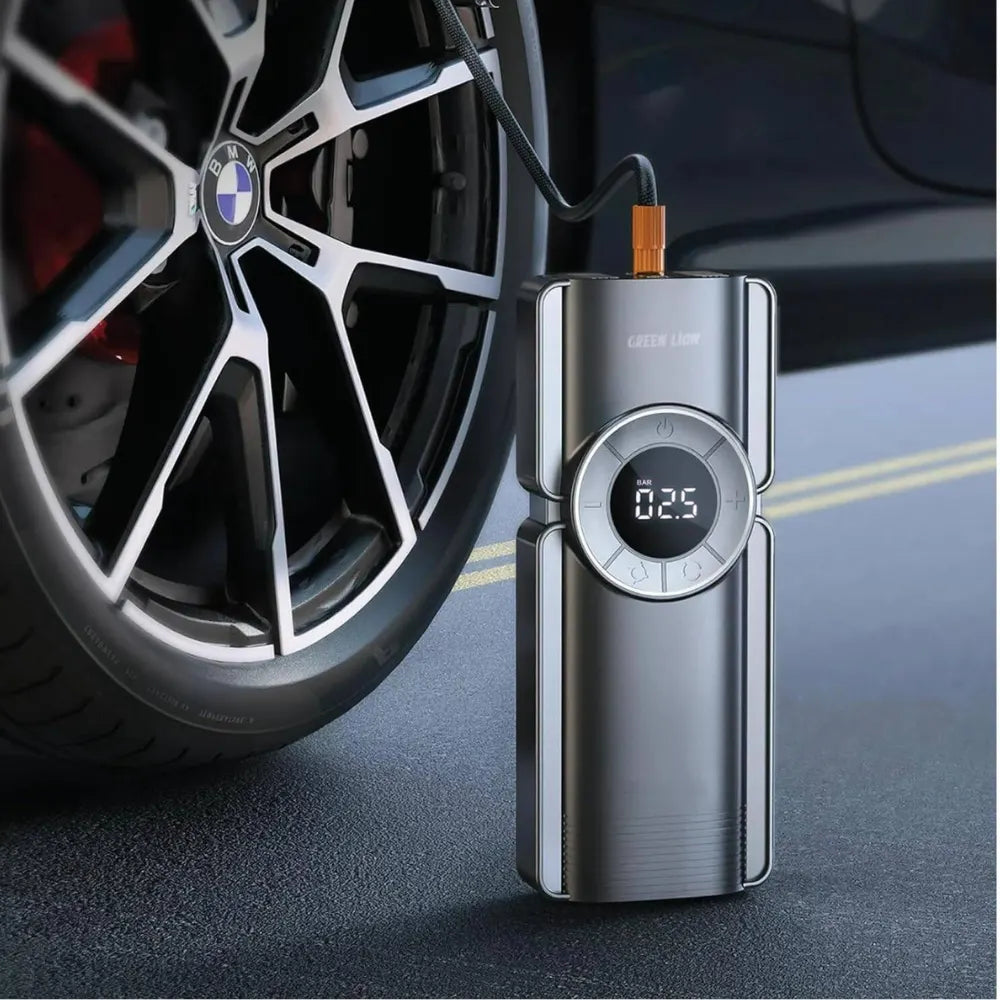 Green Lion portable jump starter inflating a car tire using the built-in air compressor