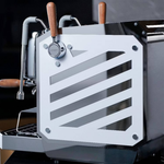 Espresso machine with a decorative metal panel on a blurred background