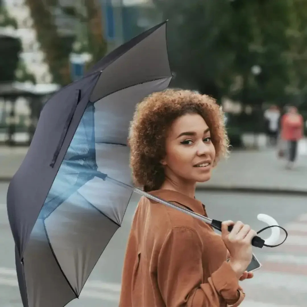 Woman using Porodo Cool Mist Umbrella with built-in fan and hydrating mist outdoors