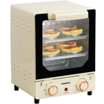 Small oven with a glass door displaying pastries on a white background